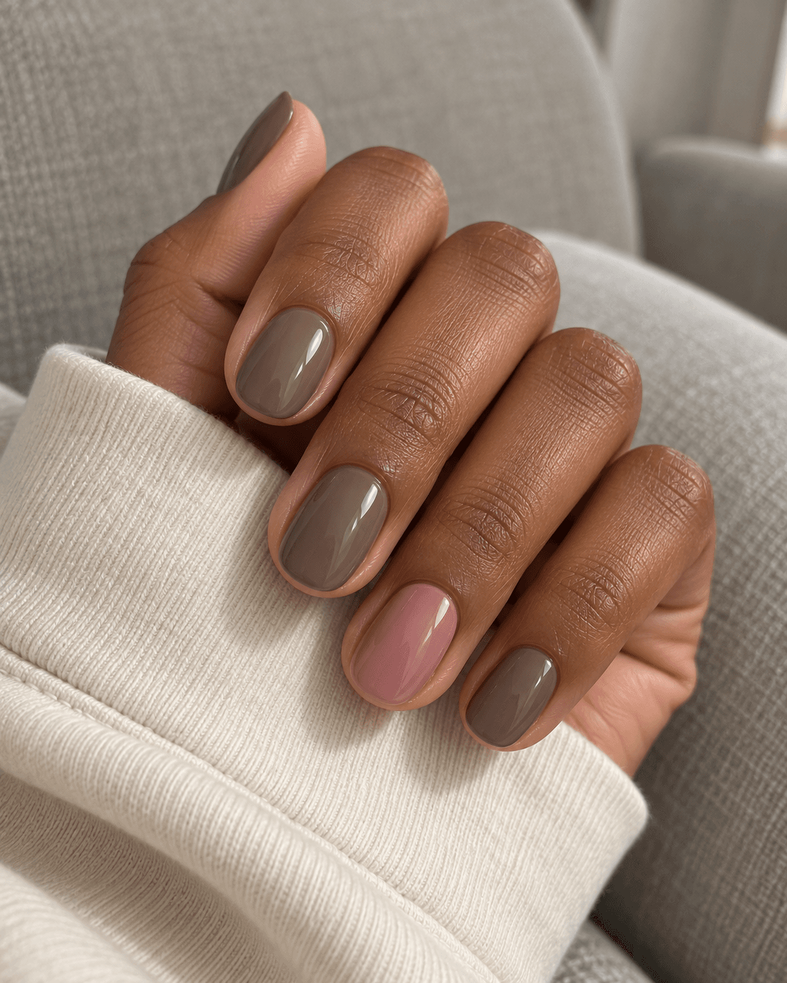 Glossy mushroom taupe nails with a solid dusty-rose ring nail.