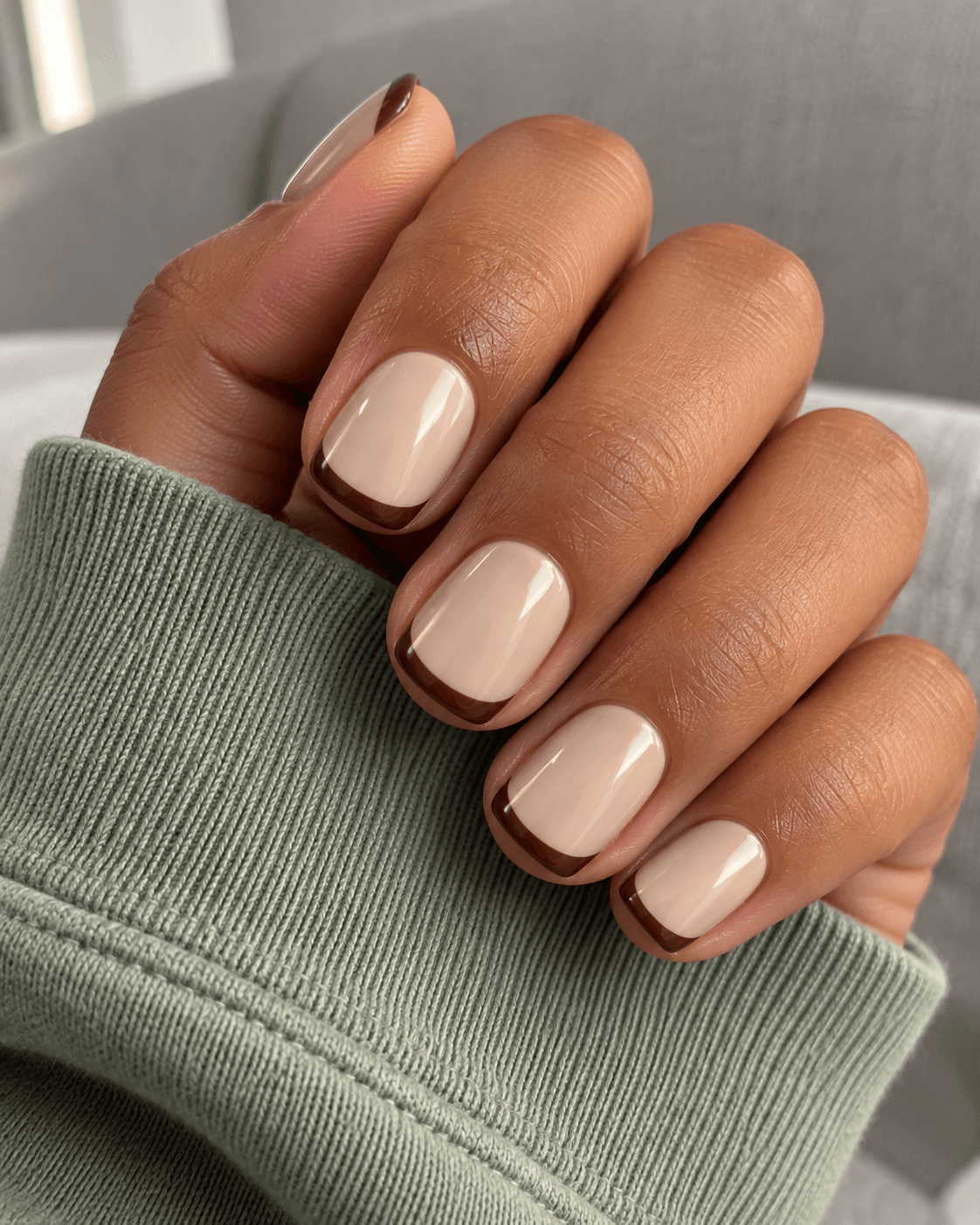 Oatmeal background with narrow chocolate tips; keep the center of each nail plain.